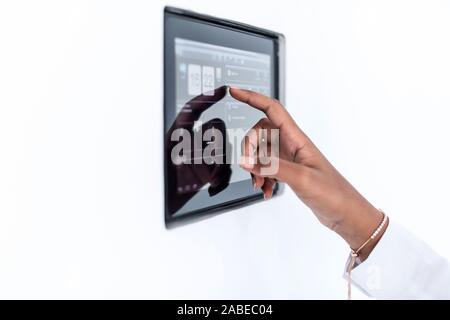 young african modern muslim woman using smart home screen control system Stock Photo