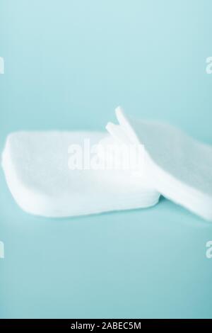 Cosmetology, cleanliness and branding concept - Organic cotton pads on mint background, cosmetics and make-up remover, hygiene and skincare beauty bra Stock Photo