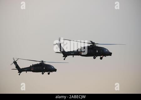 Visitors stand next to a turbofan jet of ZYB Lily Jet on display during the  Asian Business Aviation Conference and Exhibition 2013, known as ABACE 201  Stock Photo - Alamy