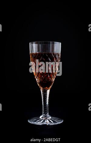 Oloroso sherry in a cut crystal sherry glass isolated on a black background Stock Photo
