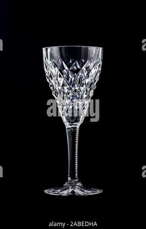 An isolated cut glass crystal wine glass on a black background Stock Photo