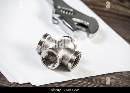 Plumbing pipeline element and adjustable wrench Stock Photo