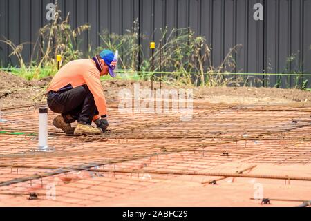 Australian builder performing steel fixing operations for a new suburban house Stock Photo