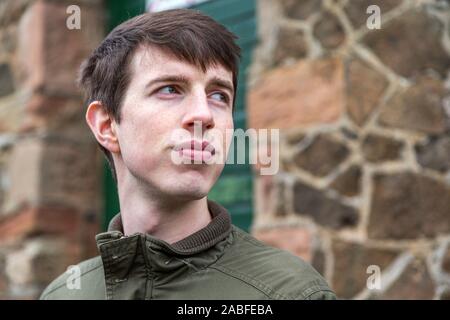 Close up of a handsome young man in his late teens or early twenties  looking into the distance with a strong optimistic expression. Stock Photo