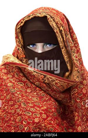 A beautiful Muslim woman looks through niqab with blue eyes Stock Photo