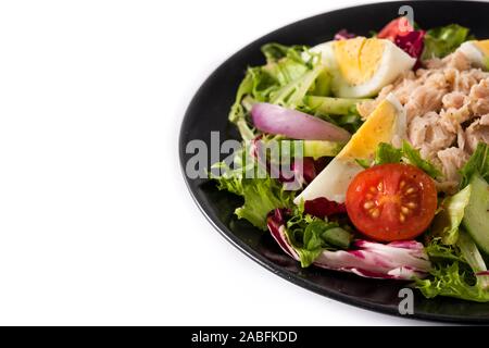 Salad with tuna, egg and vegetables isolated on white background. Stock Photo
