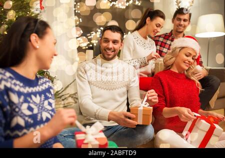 friends celebrating christmas and opening presents Stock Photo