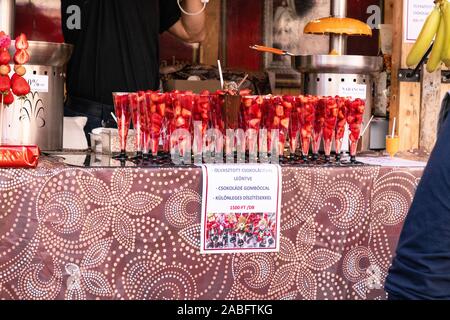 Budapest, Hungary - September 13, 2019: Strawberry sugar coated skewers. Strawberry fruit on wooden skewers Stock Photo