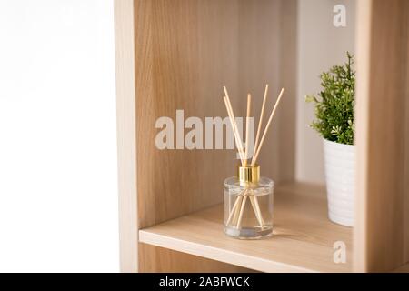 aroma reed diffuser on wooden shelf Stock Photo