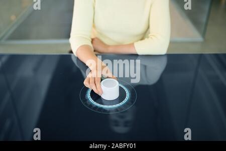 woman with control knob on interactive panel Stock Photo