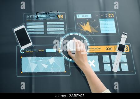 hand with control knob on interactive panel Stock Photo