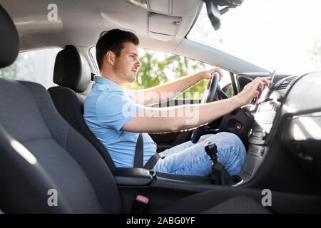 man or driver driving car and using gps navigator Stock Photo
