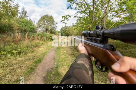 POV of male hands shooting with air rifle Stock Photo