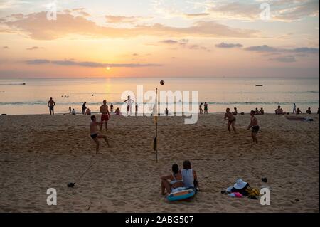 18.11.2019, Phuket, Thailand, Asia - A group of tourists plays volleyball in the sunset on Karon Beach. Stock Photo