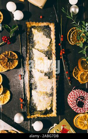 Freshly baked christmas tart  on a wooden background with various christmas decoration Stock Photo