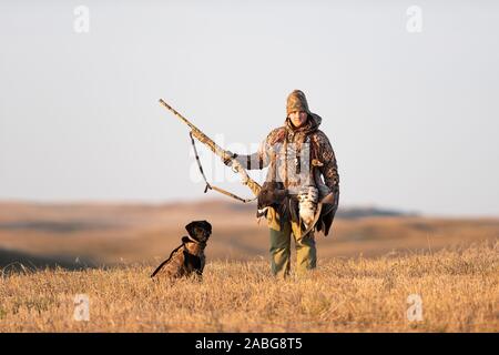 A Young Goose hunter with his Black Labrador Retriever Stock Photo