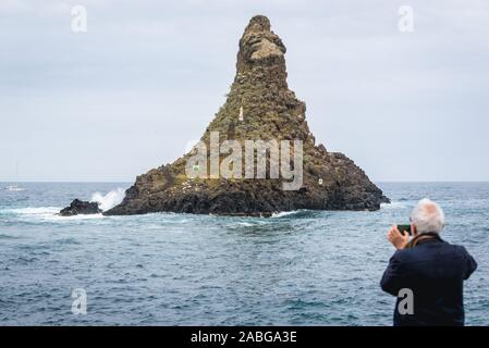 Islet with Madonna figure - one of Cyclopean Isles in Aci Trezza town, a frazione of Aci Castello comune near Catania on Sicily Island in Italy Stock Photo