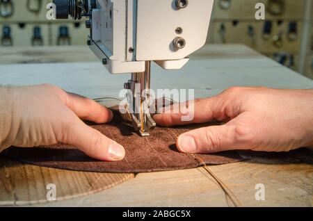 Man working with leather sewing machine Stock Photo