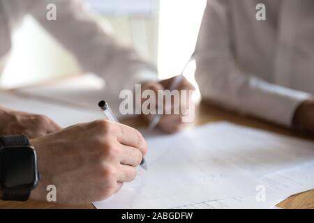 Close up of businesspeople brainstorm discussing paperwork Stock Photo