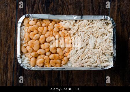 Take Away Turkish Fast Food Chicken, Rice and Baked Beans / Tavuk Pilav or Pilaf in Plastic Box Package / Container. Traditional Dish. Stock Photo