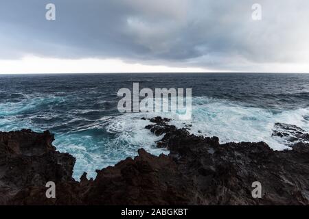 stormy sea on black volcanic coast Stock Photo