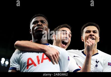 Tottenham Hotspur's Serge Aurier (left) celebrates scoring his side's third goal of the game with Harry Winks (centre) and Dele Alli during the UEFA Champions League Group B match at Tottenham Hotspur Stadium, London. Stock Photo