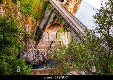 View on Fiordo di Furore arc bridge built between high rocky cliffs above the Tyrrhenian sea bay in Campania region in Italy Stock Photo