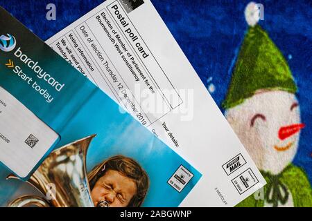 Post on Christmas mat including Postal Poll Card for forthcoming Parliamentary general election for 2019 in UK and Barclaycard offers Stock Photo