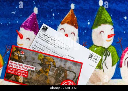 Post on Christmas mat including Postal Poll Card for forthcoming Parliamentary general election for 2019 in UK and RNLI Lifeboats Charity appeal Stock Photo