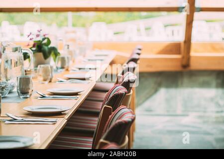 Cozy Interior Of Summer Cafe. Table And Cutlery Laid Out. Stock Photo