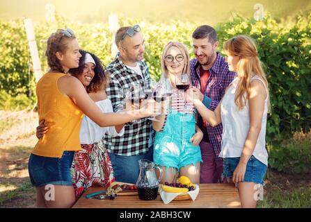 Group of Friends in wine tour in vineyard - Young people traveling and having wine tasting party - Friendship, summer, food wine healthy concept