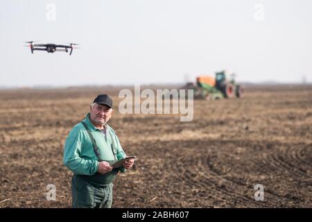 Farmer with tablet in field Stock Photo
