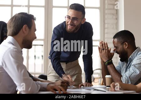 Happy young manager having fun with mixed race colleagues. Stock Photo