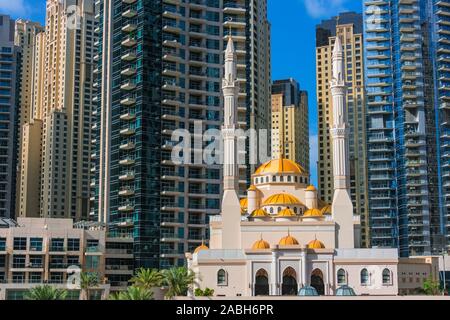 Modern residential architecture of Dubai Marina and Mohammed Bin Ahmed Almulla Mosque, United Arab Emirates. Stock Photo