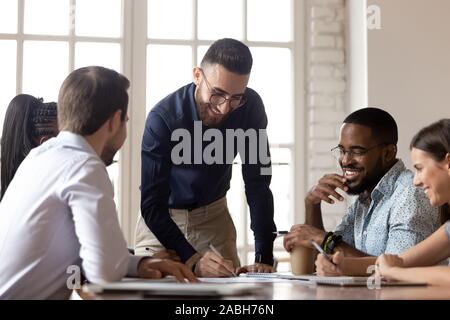 Happy motivated arabic manager editing contract or writing down notes. Stock Photo