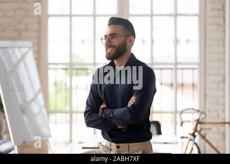Young confident pleasant businessman planning company growth strategies. Stock Photo