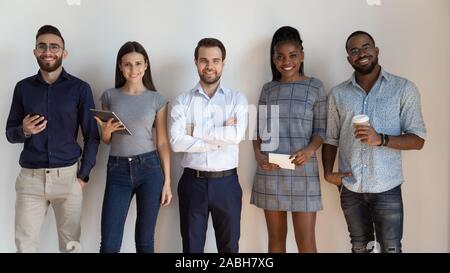 Portrait of confident young team leader with multiracial coworkers. Stock Photo