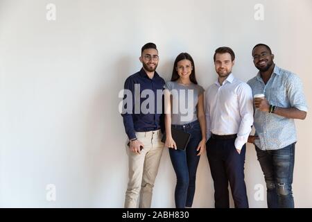 Smiling multiracial group of international company workers standing in line. Stock Photo
