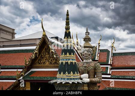 Giant Yak, Yaksha statue with large teeth, piercing eye with sword in hand protecting and guarding the famous Temple of the Emerald Buddha or Wat Phra Stock Photo