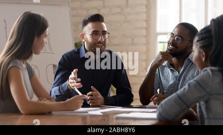 Engaged arabian businessman discussing project details with clients. Stock Photo