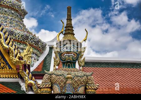 Giant Yak, Yaksha statue with large teeth, piercing eye with sword in hand protecting and guarding the famous Temple of the Emerald Buddha or Wat Phra Stock Photo