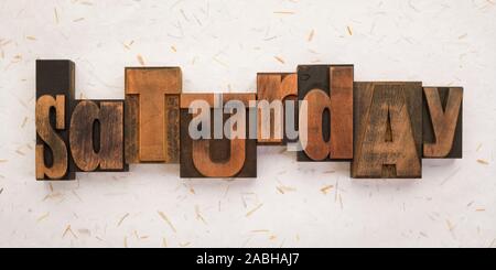 Saturday, word written with vintage letterpress printing blocks on textured background . Banner format. Stock Photo