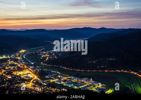 Germany, Black forest houses of city haslach im kinzigtal, streets and cityscape illuminated by night, aerial view from above with red sky, a perfect Stock Photo