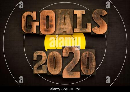 Goals 2020, phrase written with vintage letterpress printing blocks on archery target Stock Photo