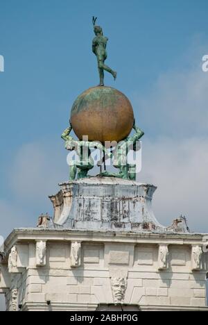 Venice, Italy: Sculpture atop the Dogana building, (Punta della Dogana), an art museum in one of Venice's old customs buildings, it's statue of Fortun Stock Photo