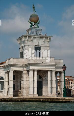 Venice, Italy: Sculpture atop the Dogana building, (Punta della Dogana), an art museum in one of Venice's old customs buildings, it's statue of Fortun Stock Photo