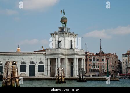 Venice, Italy: Sculpture atop the Dogana building, (Punta della Dogana), an art museum in one of Venice's old customs buildings, it's statue of Fortun Stock Photo