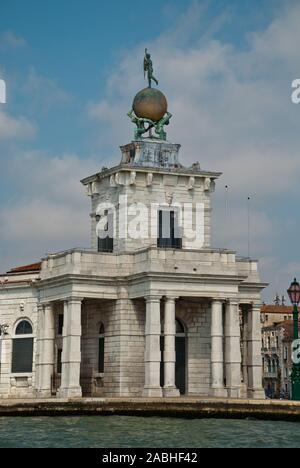 Venice, Italy: Sculpture atop the Dogana building, (Punta della Dogana), an art museum in one of Venice's old customs buildings, it's statue of Fortun Stock Photo