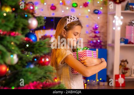 Beautiful ten-year-old girl received a gift from Santa Claus Stock Photo