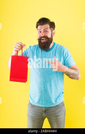 goods for men. Man with package. cyber monday concept. little pleasantness. bearded man go shopping. store for men. mature male beard with purchase. happy hipster hold red paperbag. best offer. Stock Photo